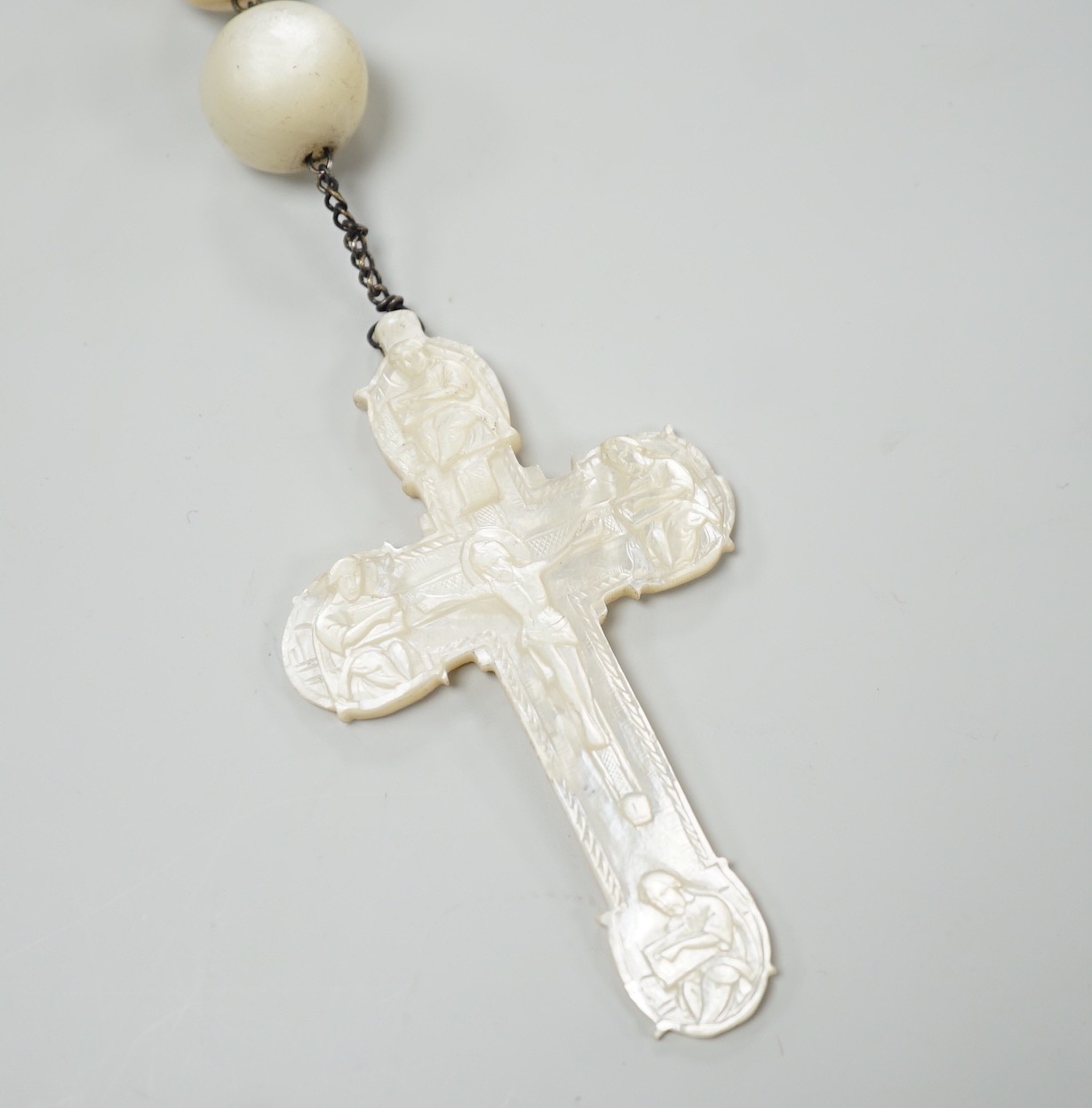 A long mother of pearl rosary, 158cm, with carved mother of pearl crucifix pendant, 8cm.